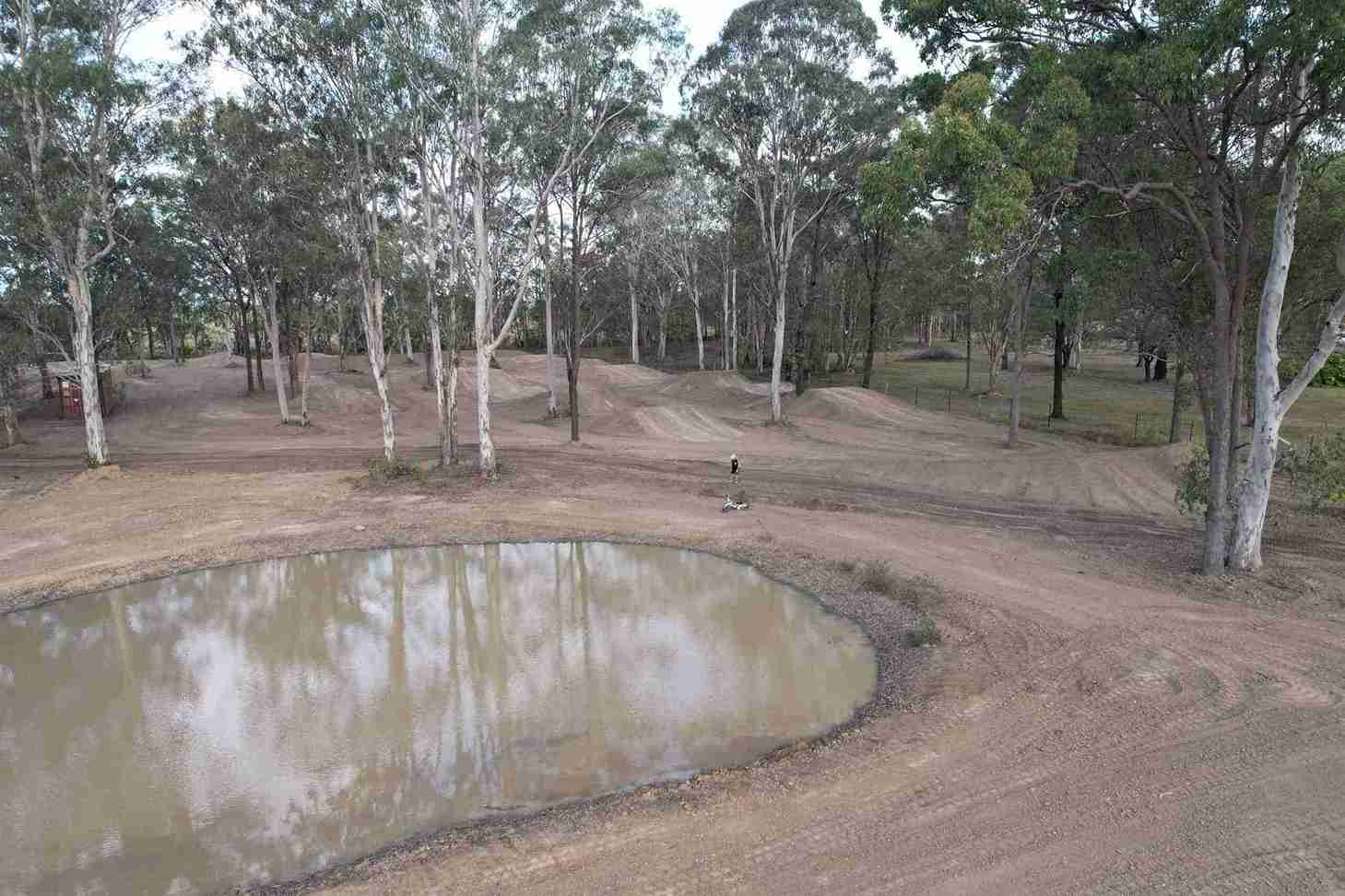 Dirt bike track with a small pond