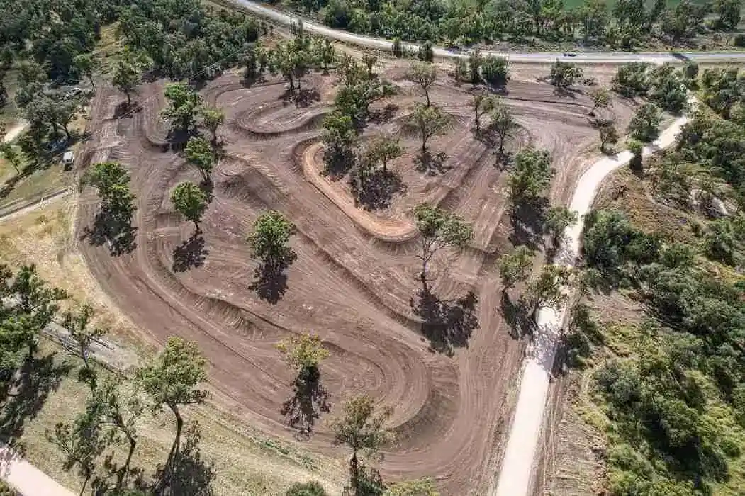 Freshly built dirt track with winding paths and trees