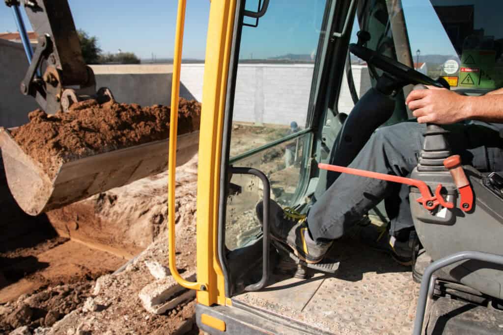 Earthworks contractor operating excavator